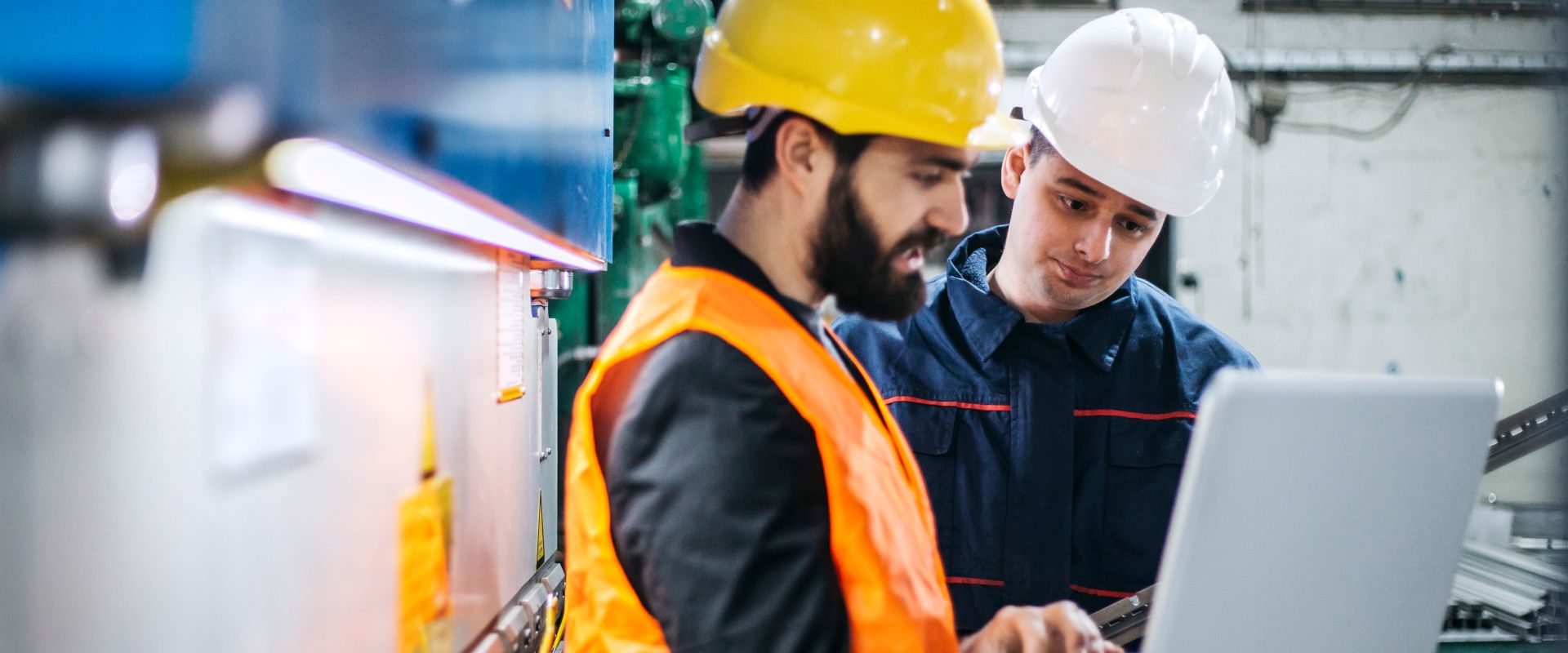 boiler maintenance men monitoring boiler room on laptop