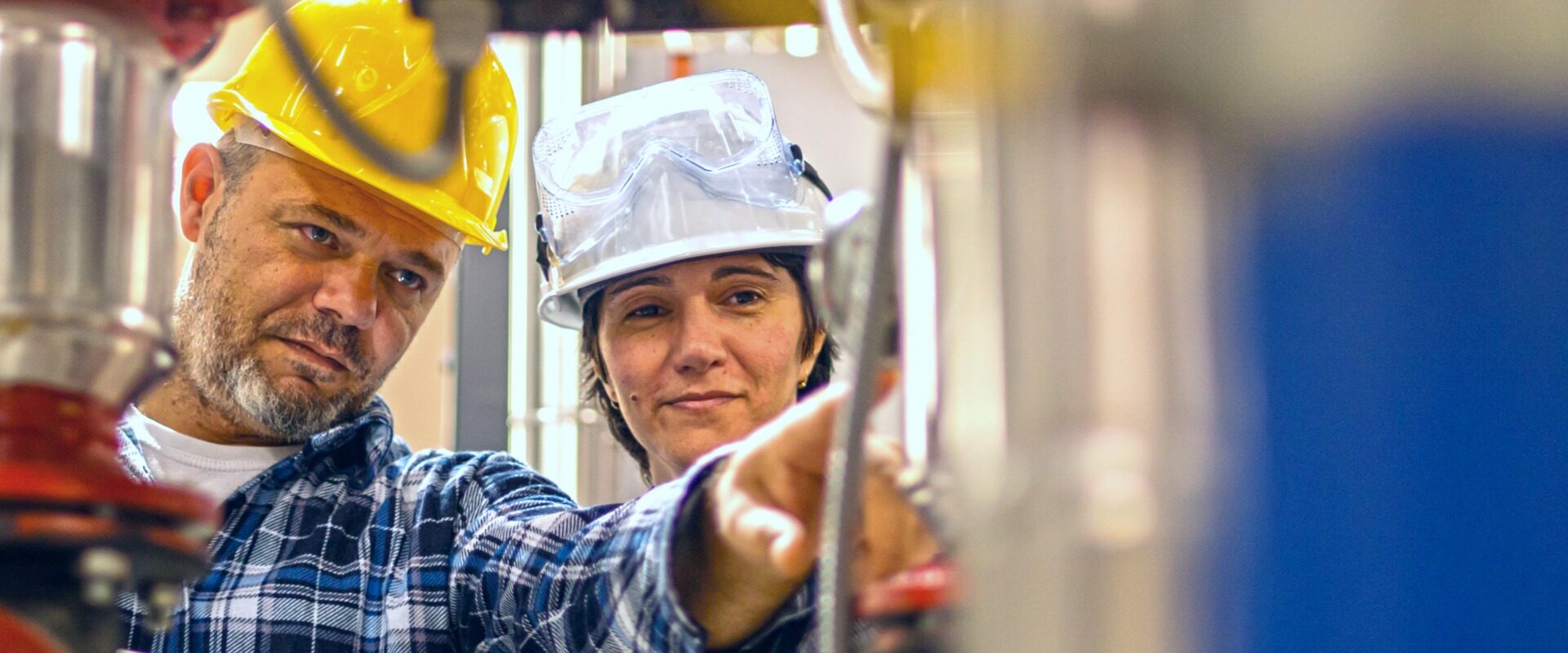 Two people inspecting boiler steam traps