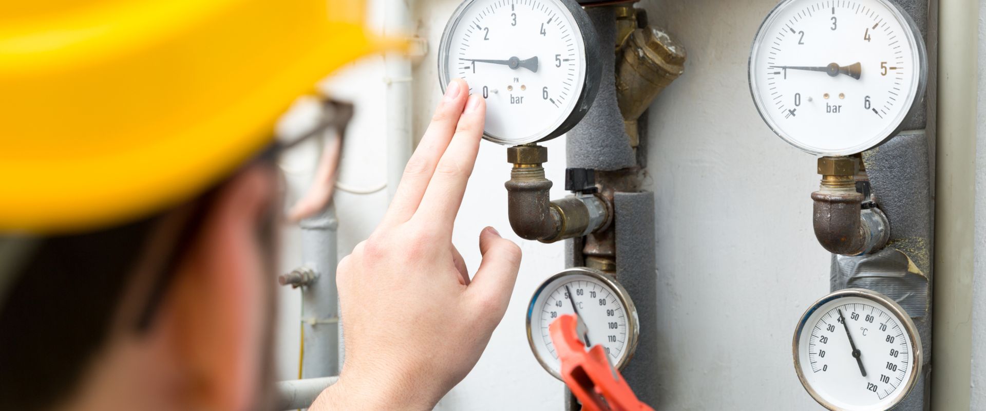 Technician looking at gauges cold boiler system